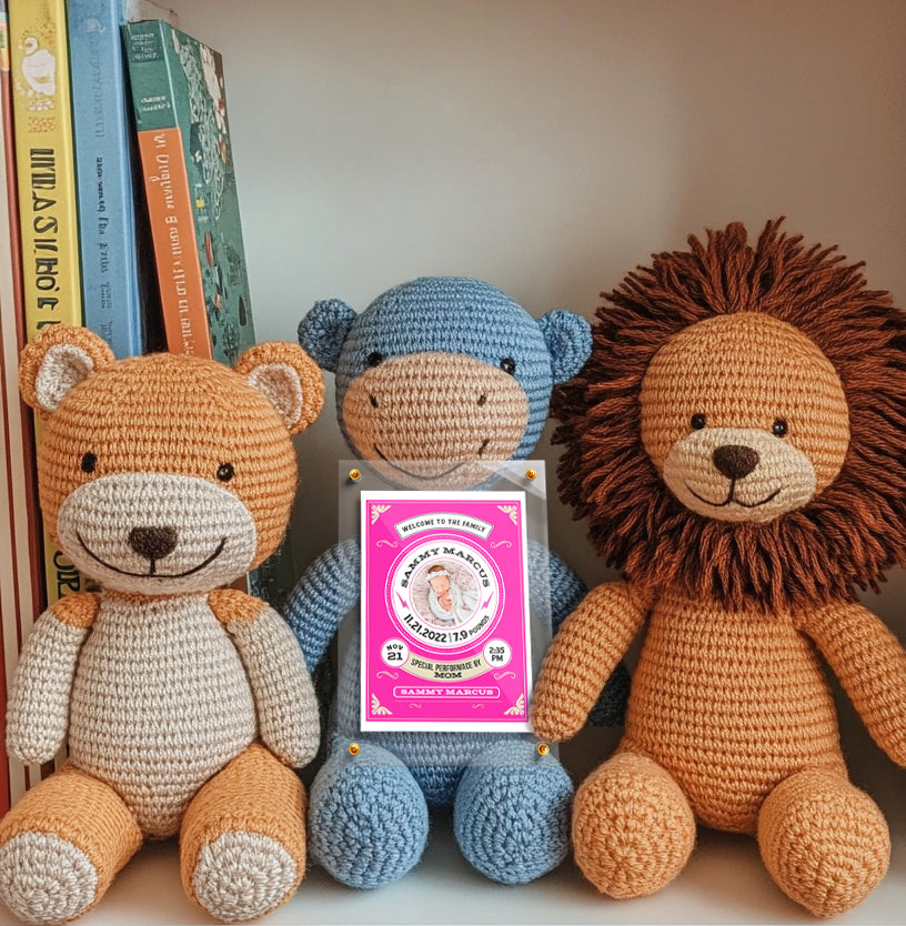 Three crocheted animals (bear, monkey, lion) with a pink label in the center on a white surface.